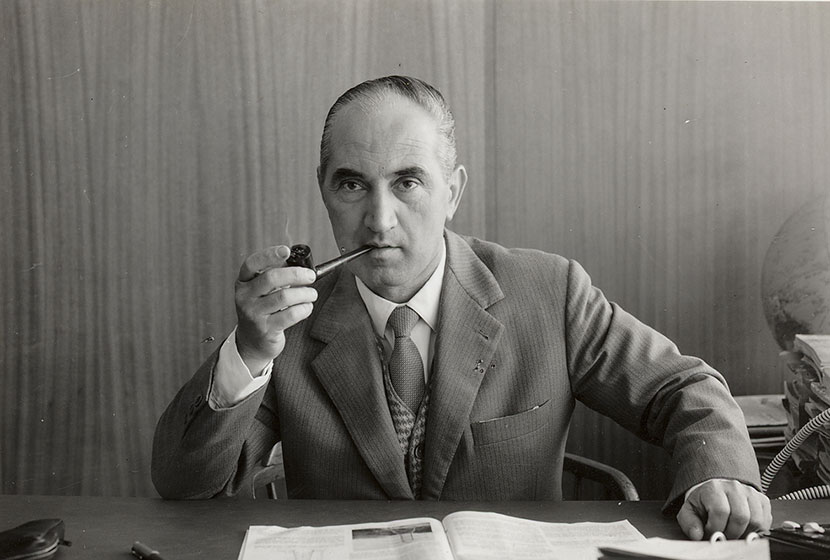 1960s. Pipe-smoking Franco at his desk in Transfield House.